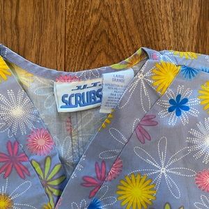 Size large light blue floral scrub top.